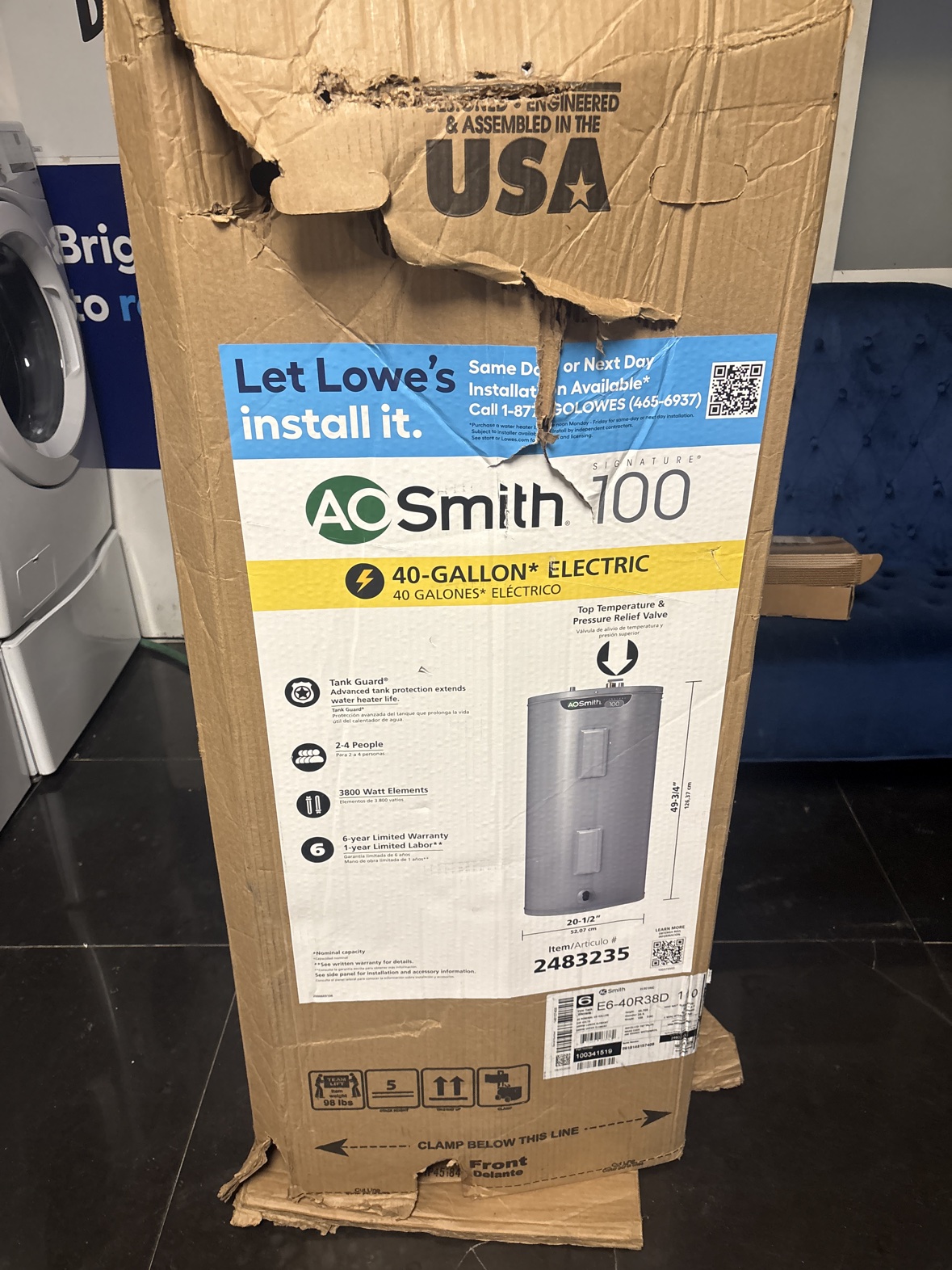 Boxed A. O. Smith Signature 100 40-gallon electric water heater with visible damage to the outer box