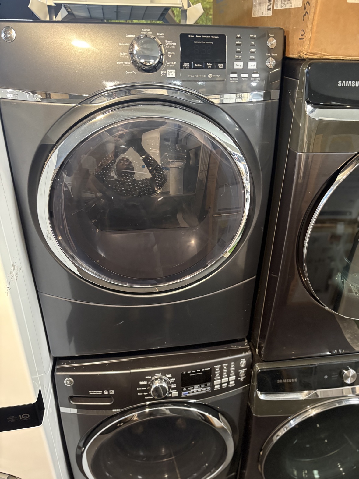 GE charcoal black front-load dryer, front view