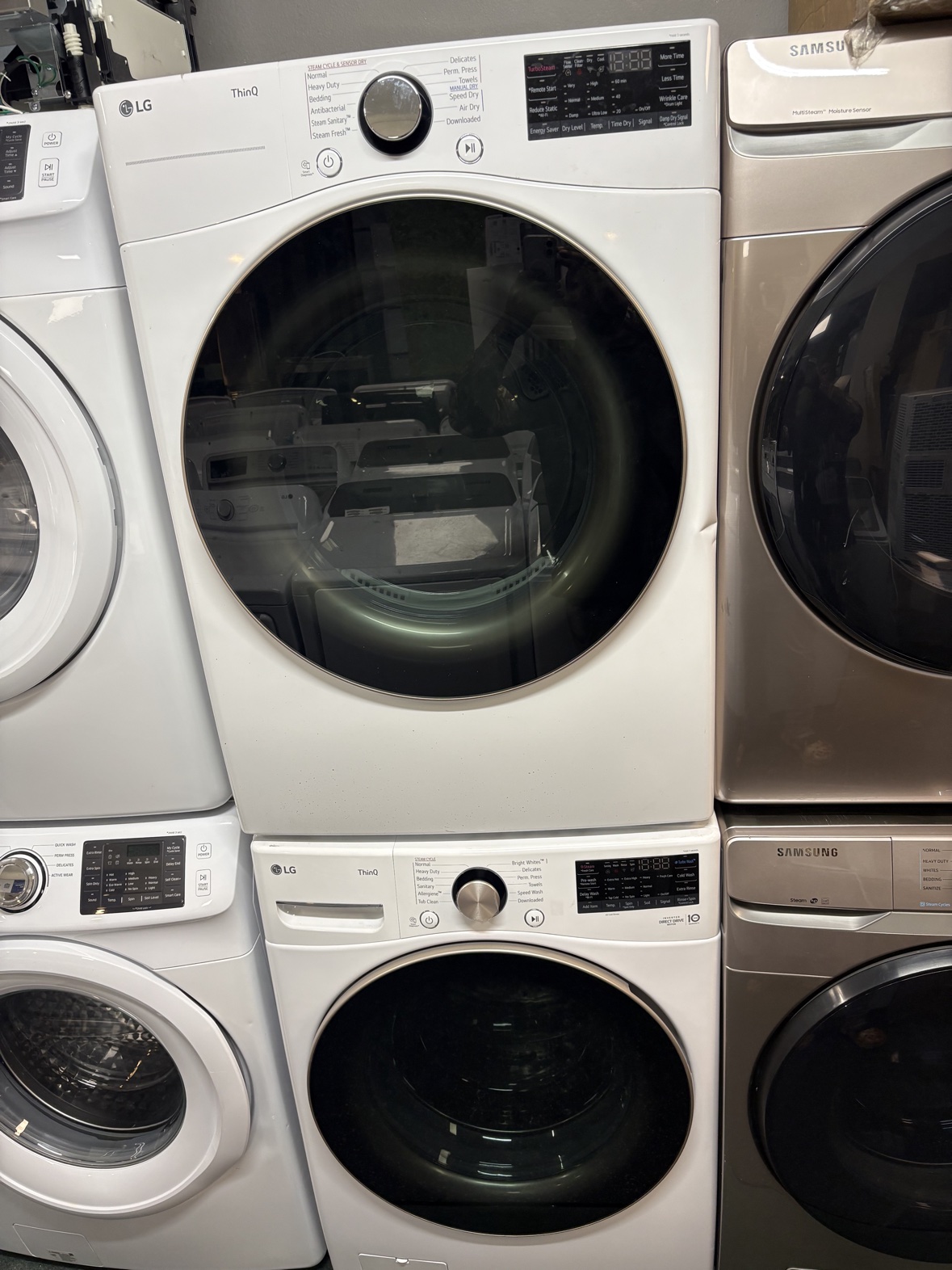 White LG ThinQ stacked front-load washer and dryer set, scratch and dent