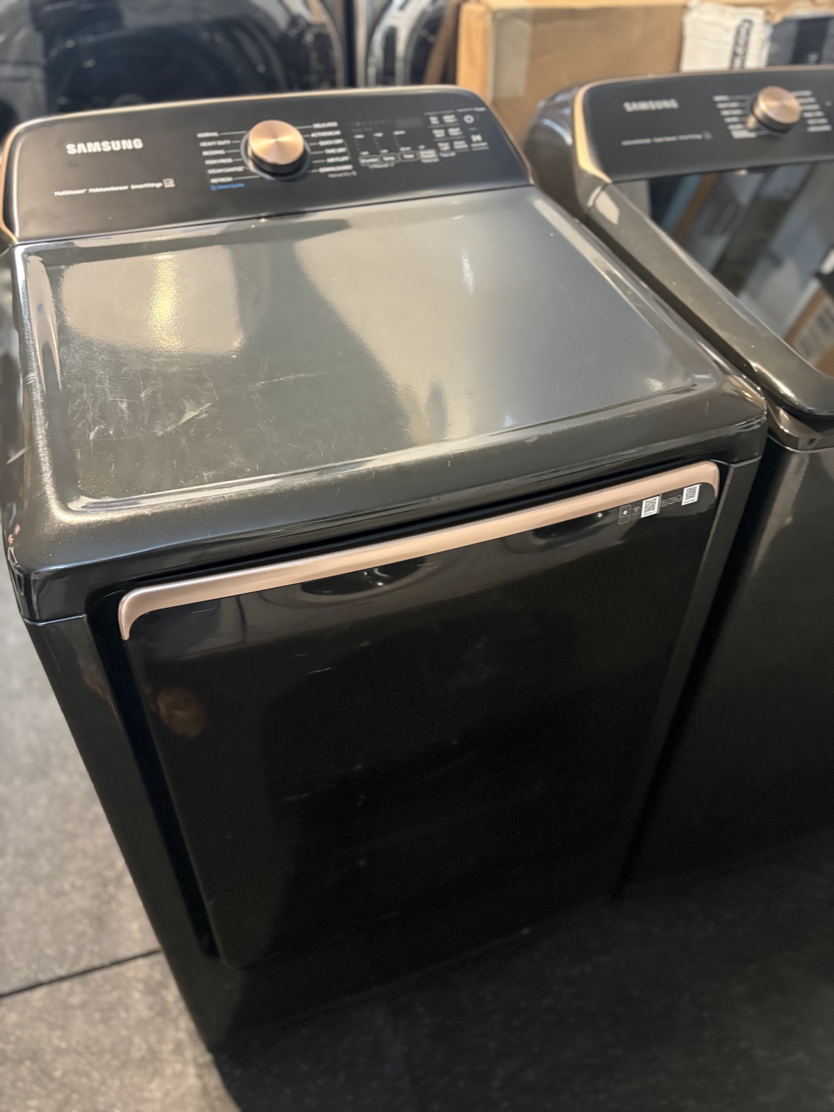 Samsung black stainless washer and dryer set from an angle