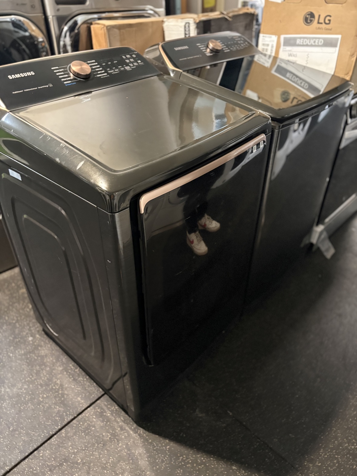 Samsung black stainless top-load washer and dryer set with rose gold dials